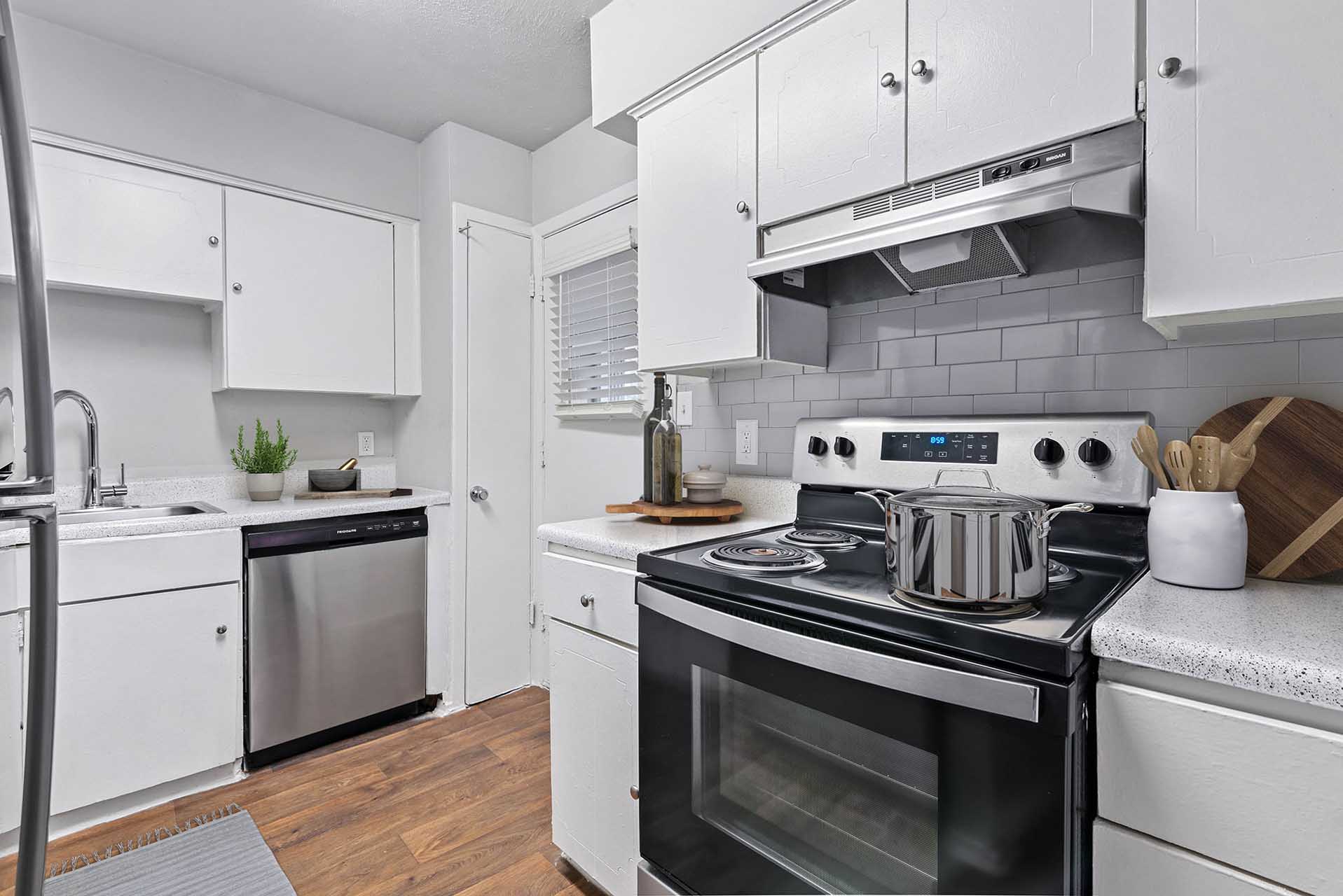 Renovated kitchen with stainless steel appliances and white cabinets